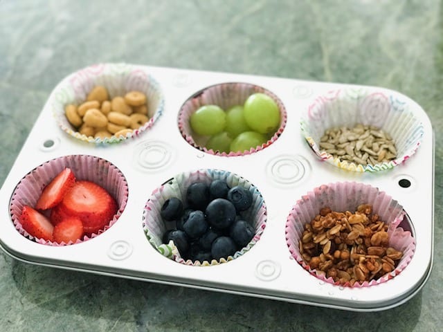 Muffin tin with fruit, seeds and granola