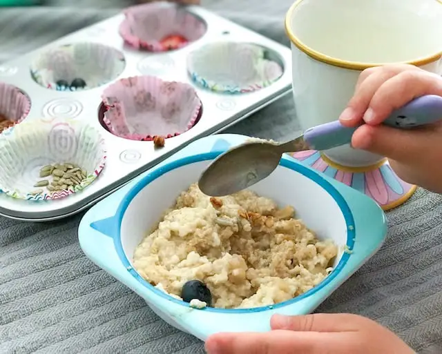 A bowl of oatmeal with a muffin tin