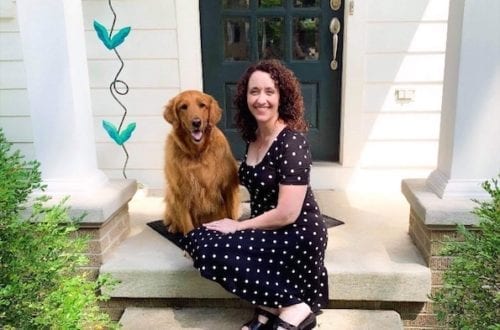woman with curly hair and polka dot dress and dog who fought chronic migraine