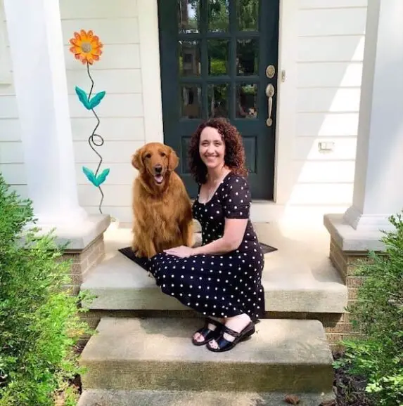 woman with curly hair and polka dot dress and dog who fought chronic migraine