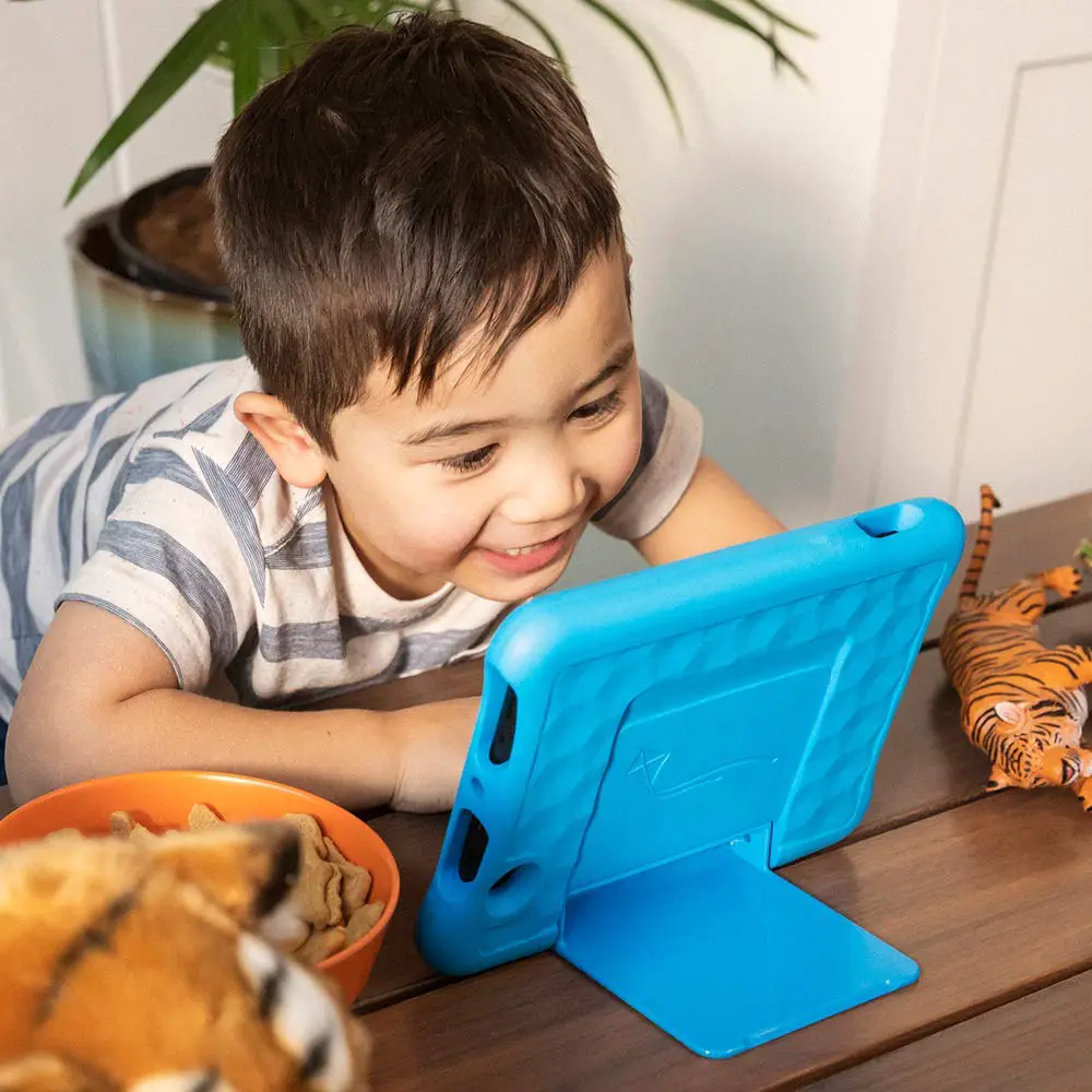 A boy using an Amazon Fire Tablet in a blue case, which is one of the top rated gift ideas for kids of moms with migraine. 