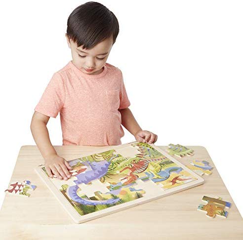 A boy doing a puzzle makes it to the best gift ideas for kids.