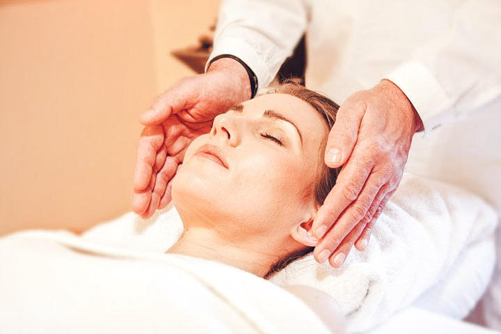 Woman getting a chiropractic adjustment from a chiropractor to relieve migraine