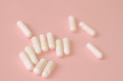 white capsules on a pink background reglan for migraine